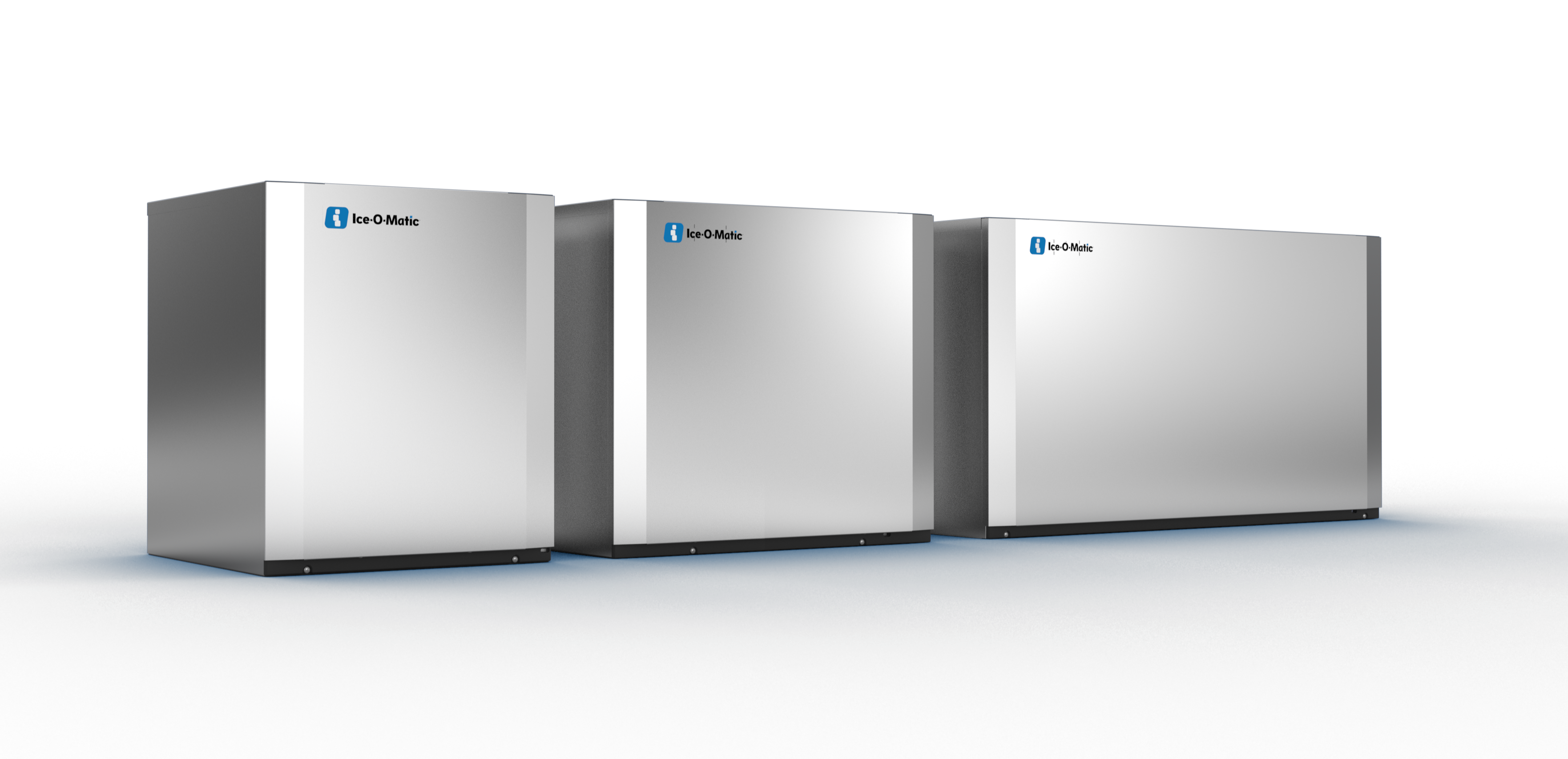 Three Ice-O-Matic cube ice makers lined up against a dark backdrop